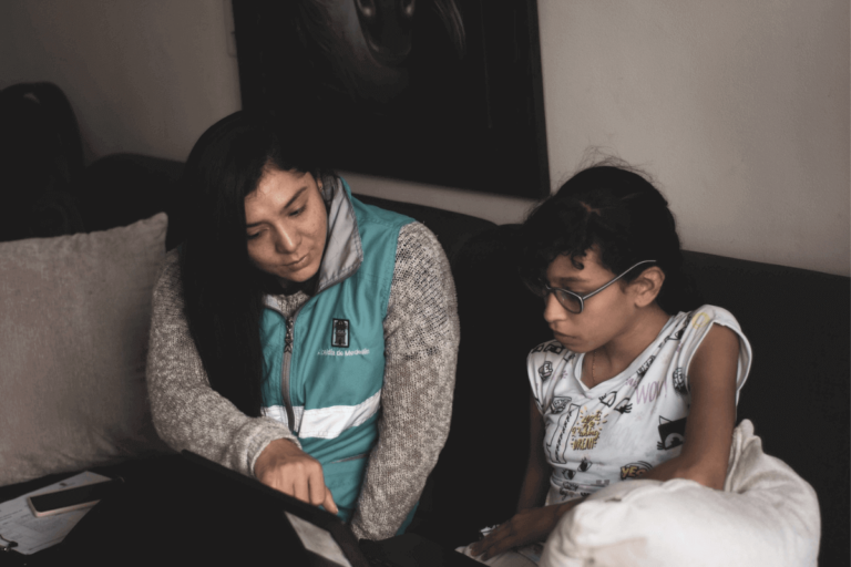 Fotografia de mediadora pedagogica junto a una estudiante del programa Primaria Incluyente